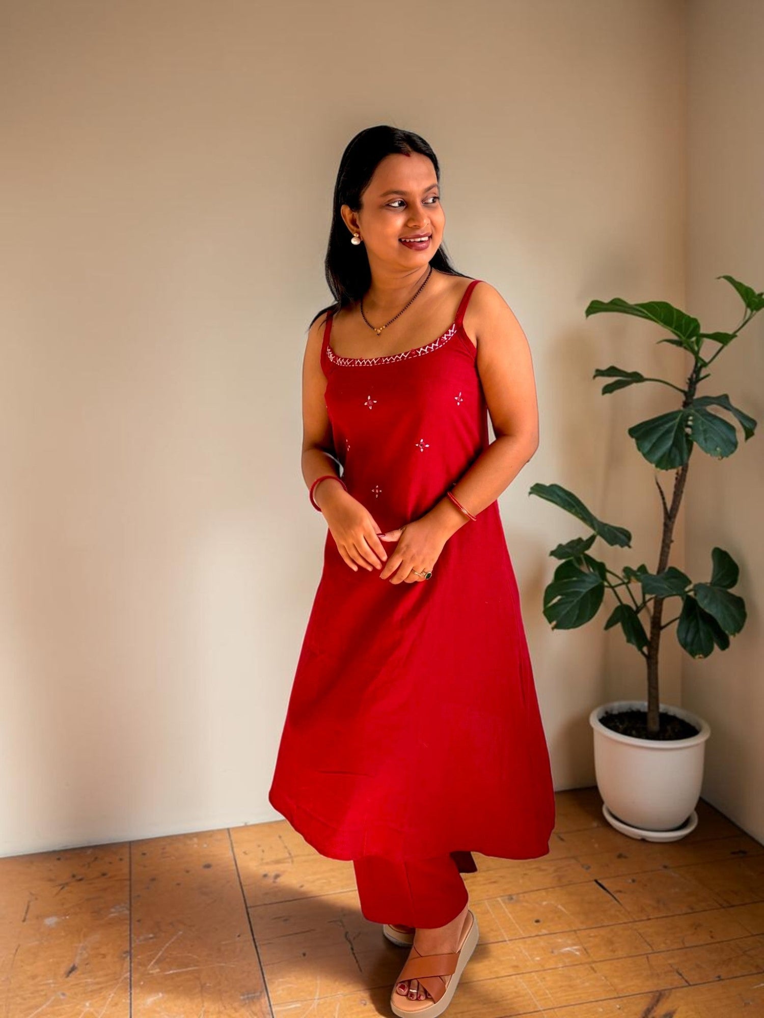 Vasanam red spaghetti strap kurta with white embroidery and matching pants set.